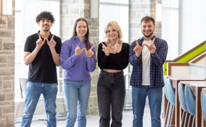 Photo of Western Grad students showing W hands